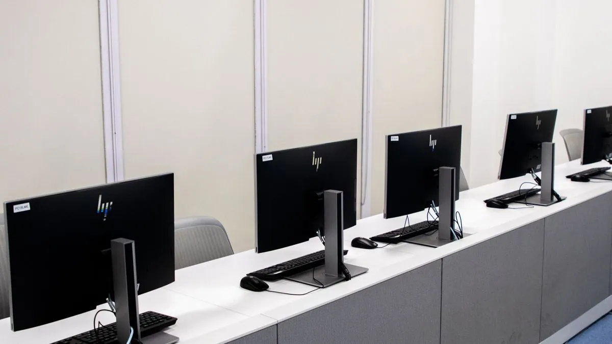 Rows of desktop computers set up and ready for an office